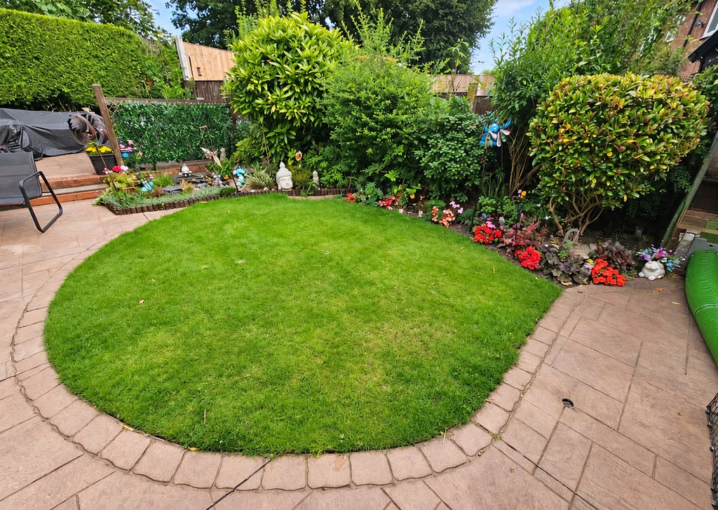 A curved lawn inside a paved surround