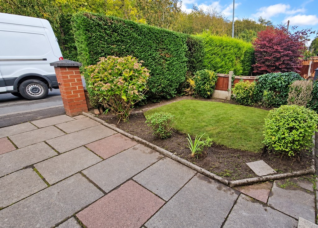 A front garden after a hedge and shrub tidy