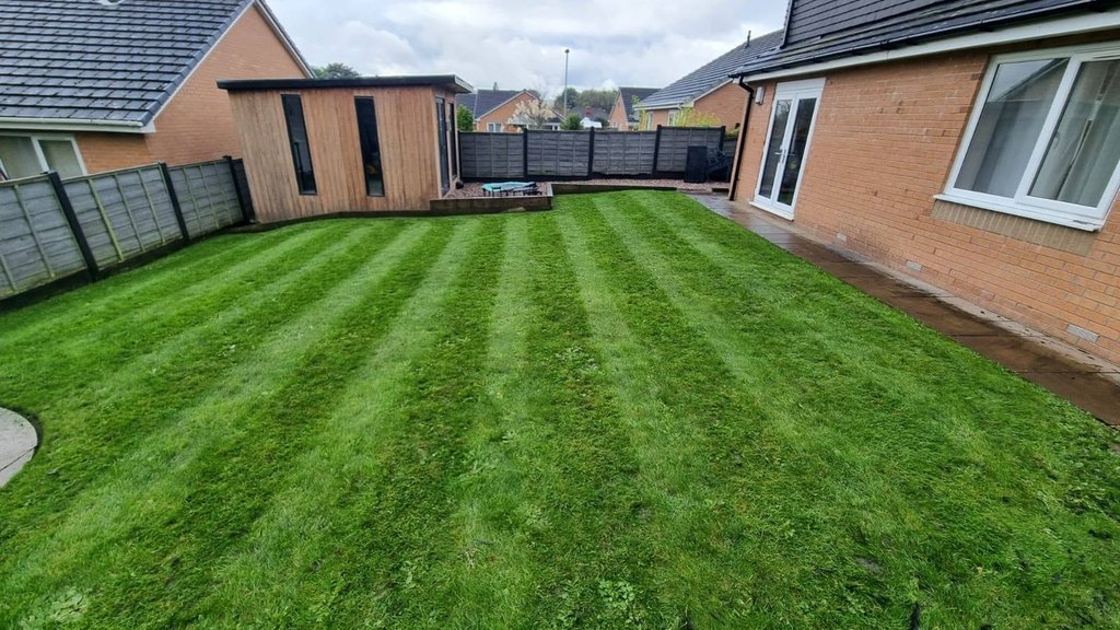 Striped garden lawn and timber garden room